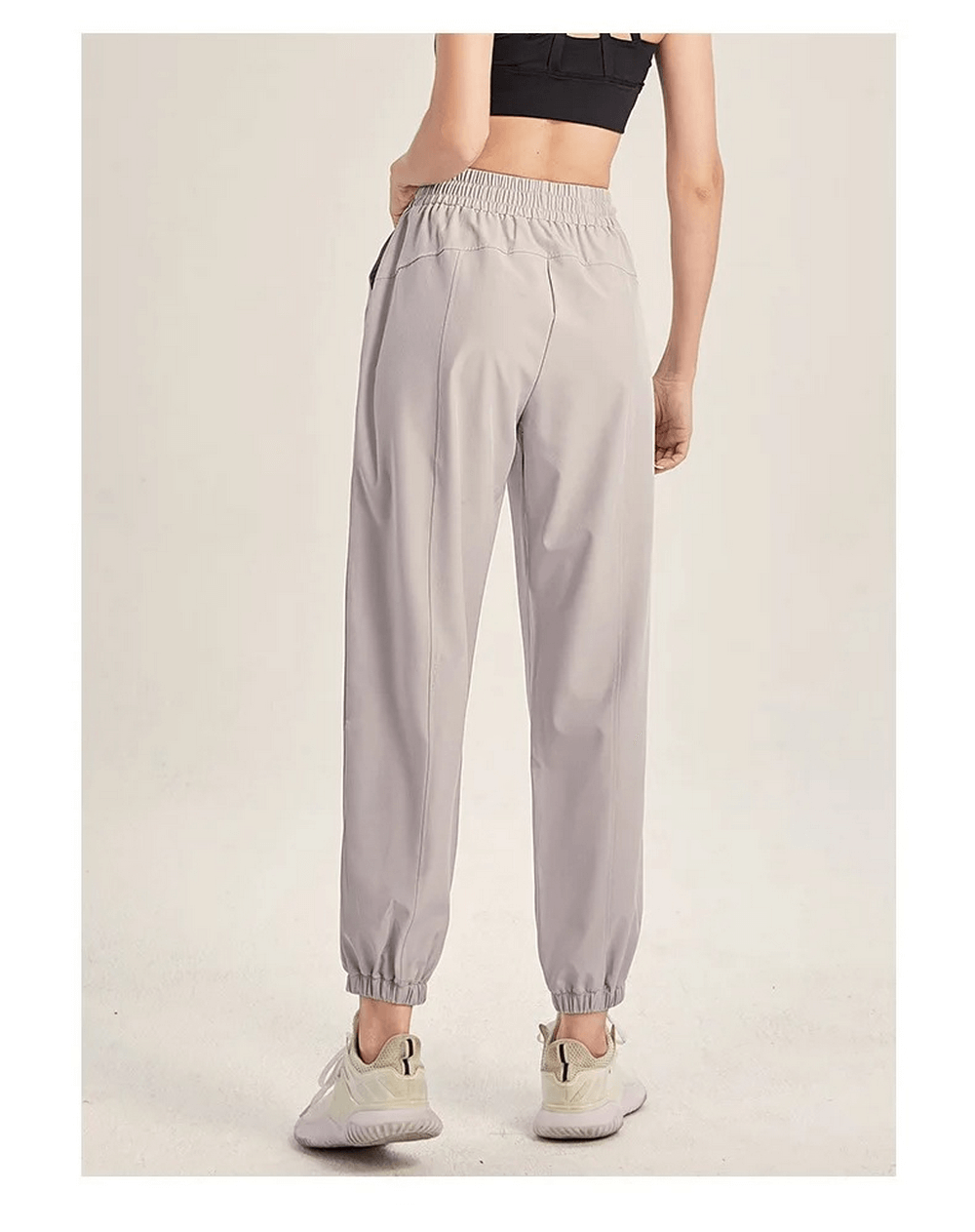 Women's gray drawstring joggers for yoga and gym workouts, shown from the back, offering flexible, durable fit for running and dance.